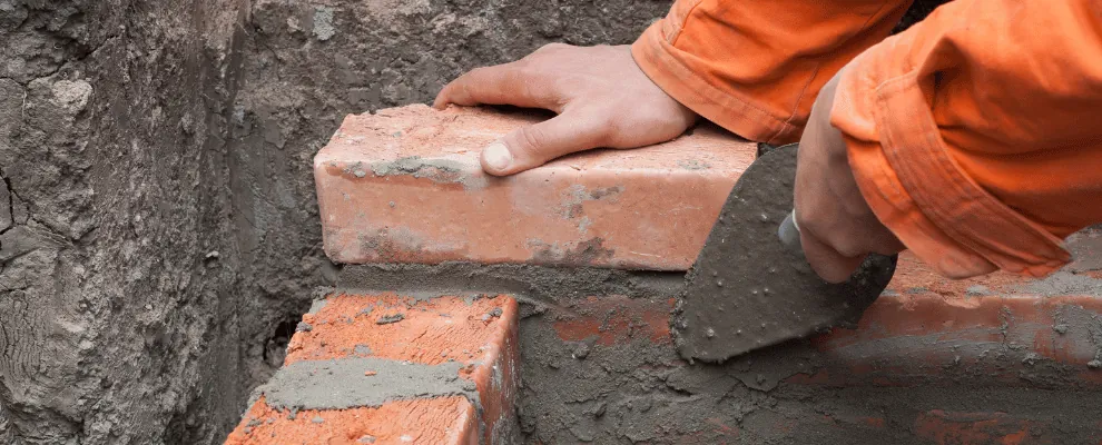 Brick wall being professionally repointed with fresh mortar